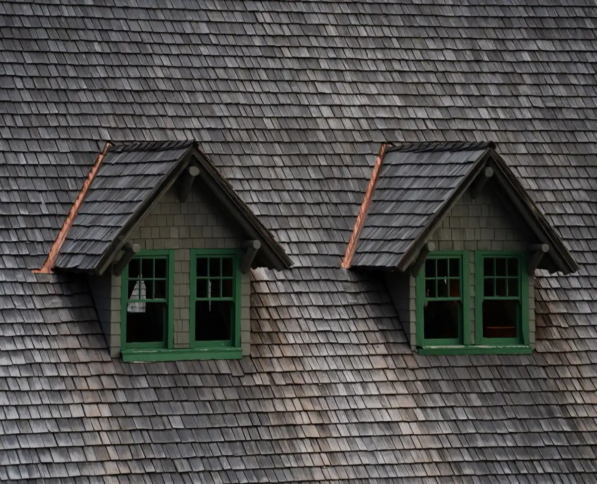Dormers on a shingle roof in Cleveland, TN, where step flashing and kickout flashing carry water past the walls